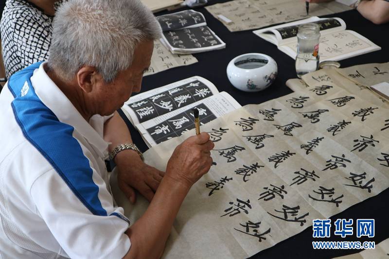 6月24日,张世宏老人在海鑫社区活动中心练习书法.