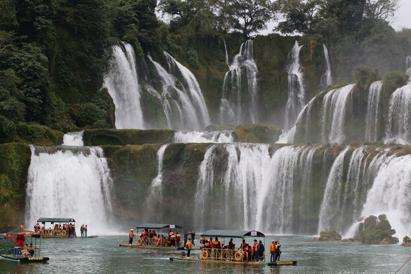 德天跨国瀑布景区内，游客乘竹筏近距离感受瀑布的魅力。梁婷摄