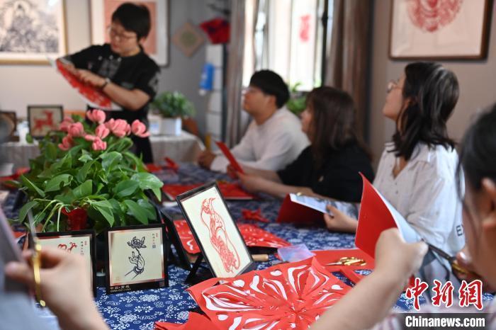 6月6日，在甘肃敦煌青年夜校课程中，青年学员学习敦煌非遗剪纸课程。李亚龙 摄　　